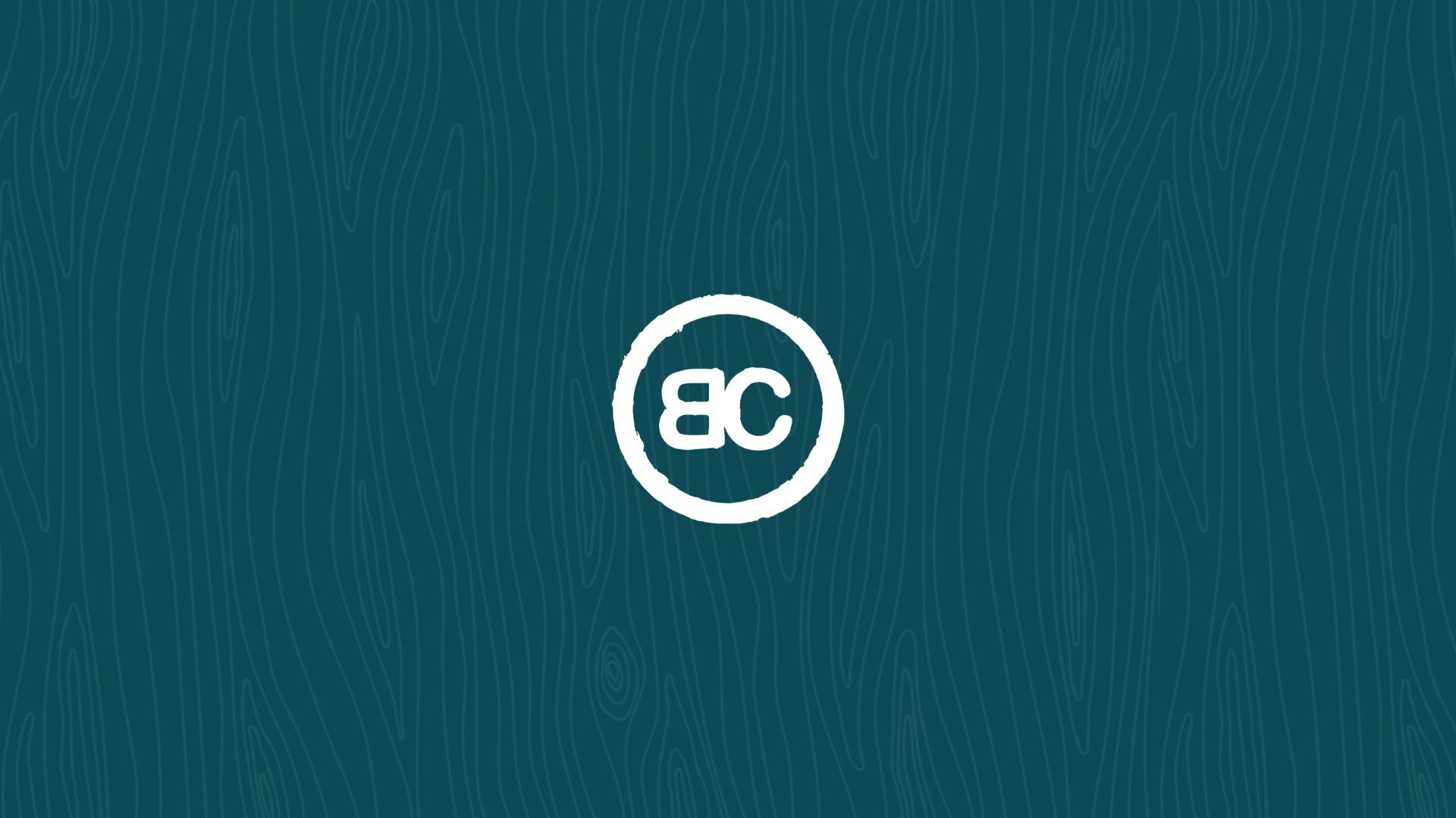 White BC monogram inside a circle on a teal background with a subtle wood grain texture, evoking the spirit of accessible travel.